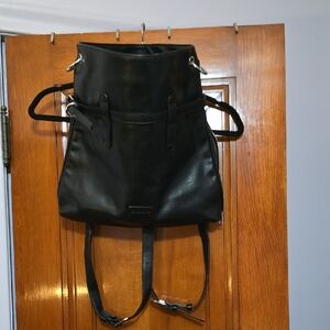 BLACK VEGAN LEATHER CONVERTS IN TO AN OVER THE SHOULDER TO BACK PACK PURSE/TOTE.